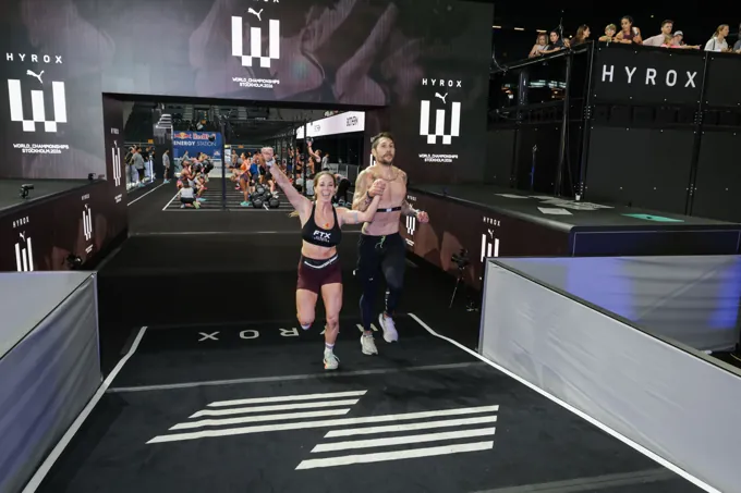 FTX mixed doubles team crossing the finish at the HYROX World Championships in Stockholm