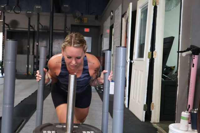 Athlete grinding through a sled push at FTX