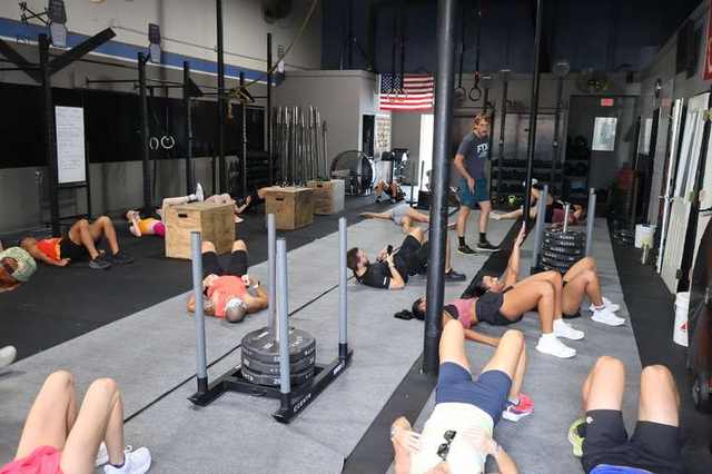 The class recovering on the floor after a workout at FTX