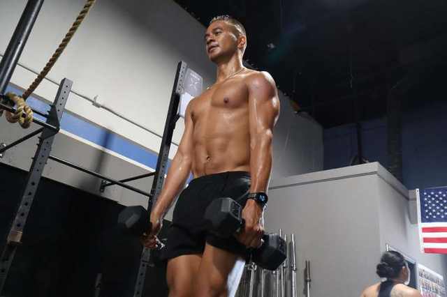 Athlete on a dumbbell carry at FTX