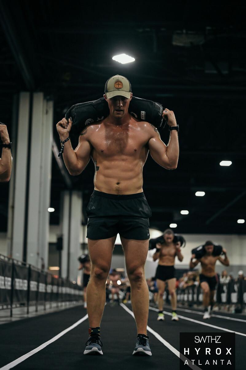 Clayton Marshall on the sandbag lunge station at HYROX Atlanta