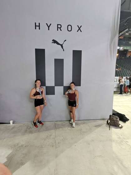 FTX athletes with medals at the HYROX Worlds wall