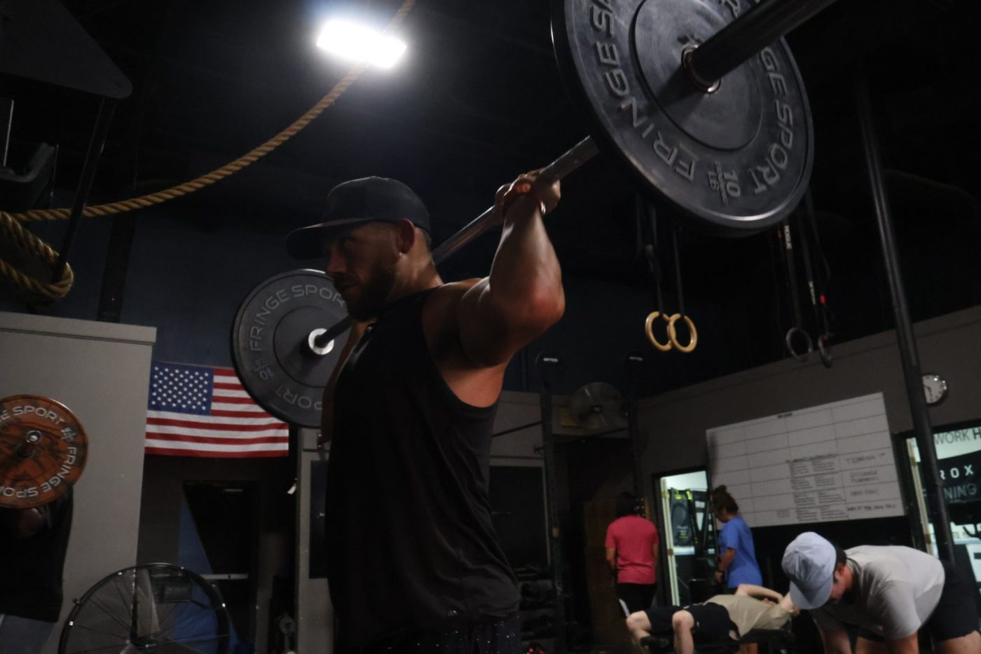 A coach and member working through a lift at FTX Fort Worth