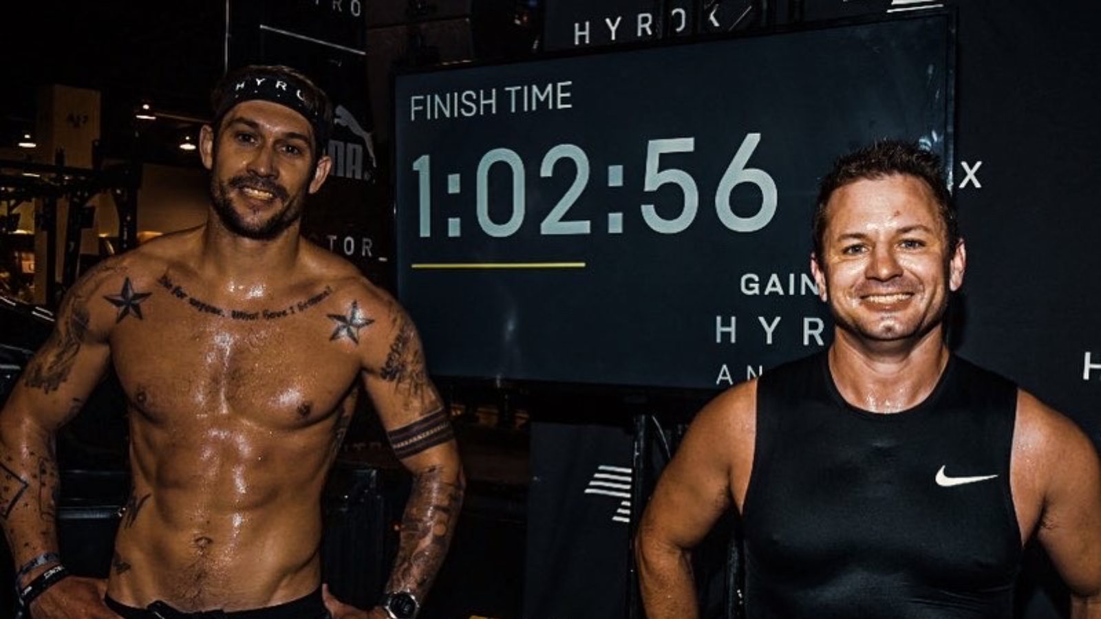 Race clock and finish time board at a HYROX event