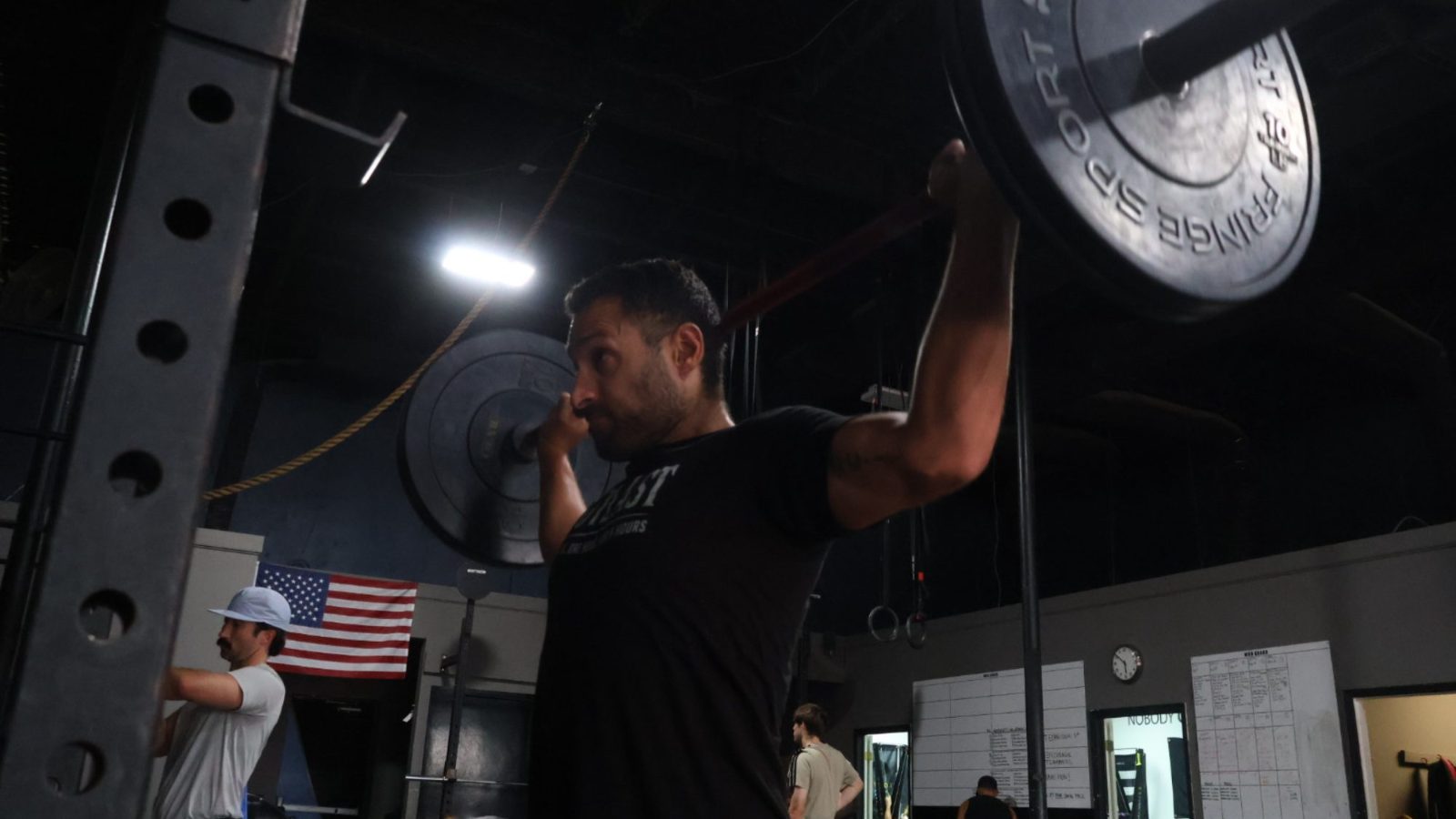 Barbell overhead during a class at FTX, Fort Worth